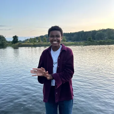 Mack Case ’24 in front of water, waving