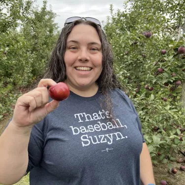 Emily Fitzgerald holding up an apple.