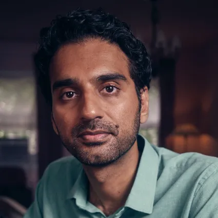 Headshot of Haider Shahbaz wearing a light green collared shirt.