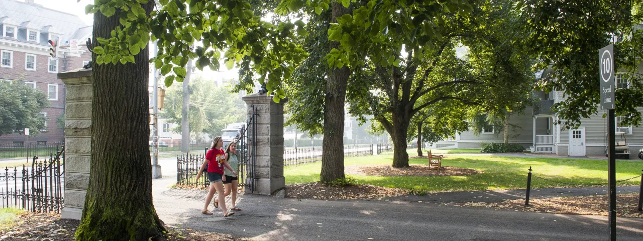 Two students walking on to campus.