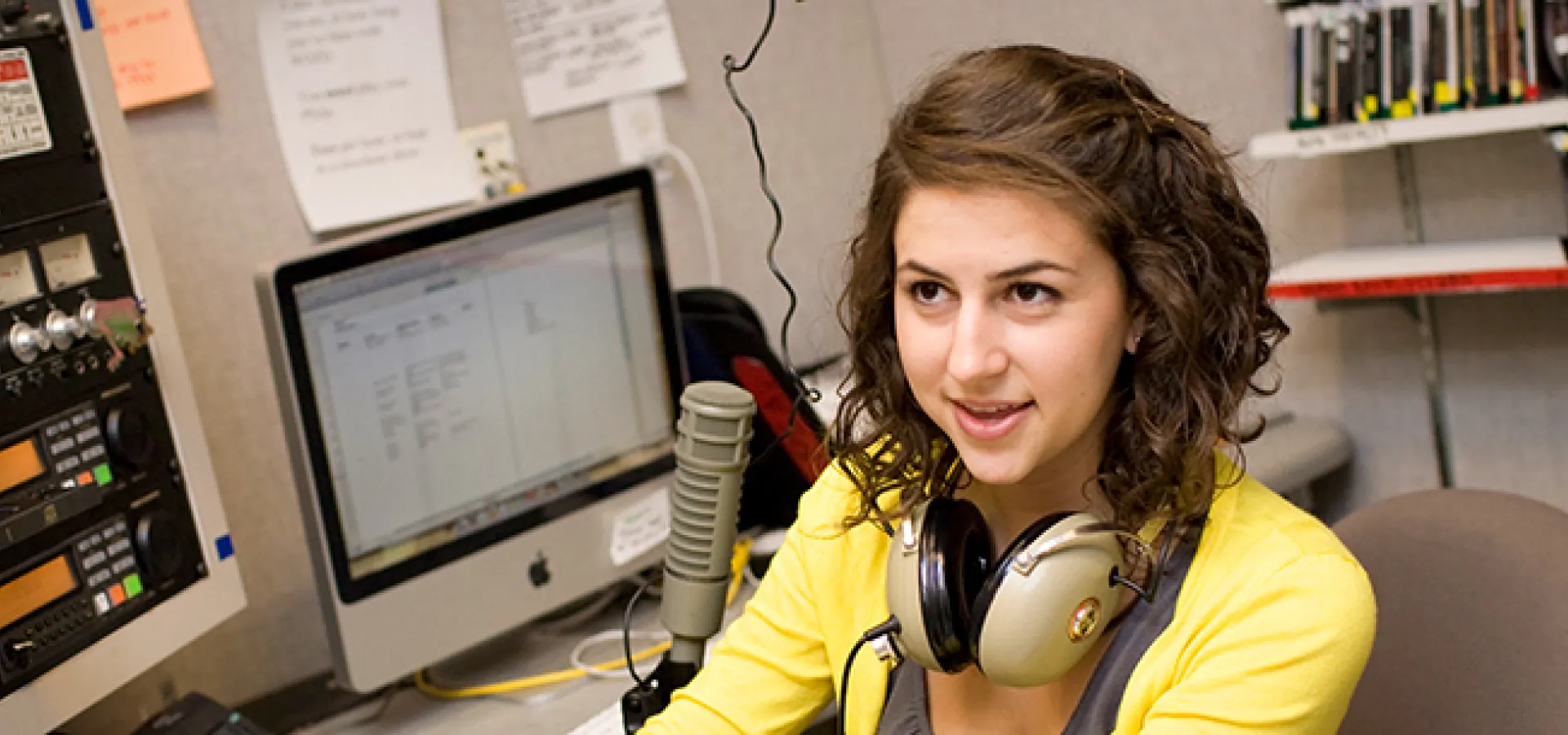 Student at the control board of the college radio station