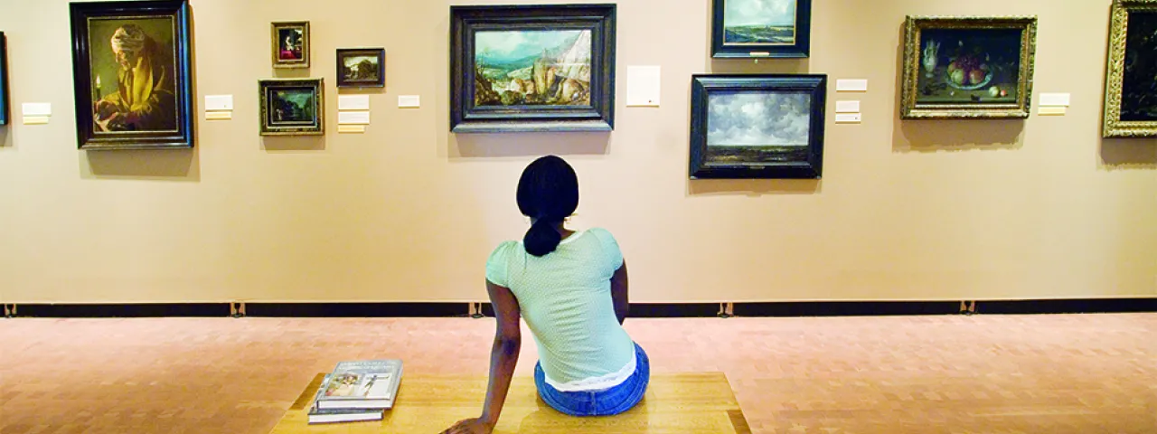 Student looking at paintings in the Smith College Museum of Art