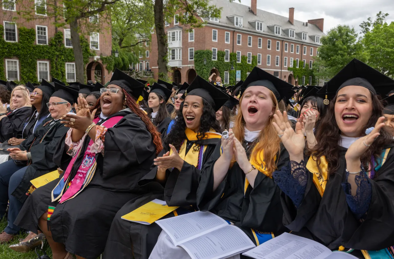 Graduates cheer during Commencement in the Quad