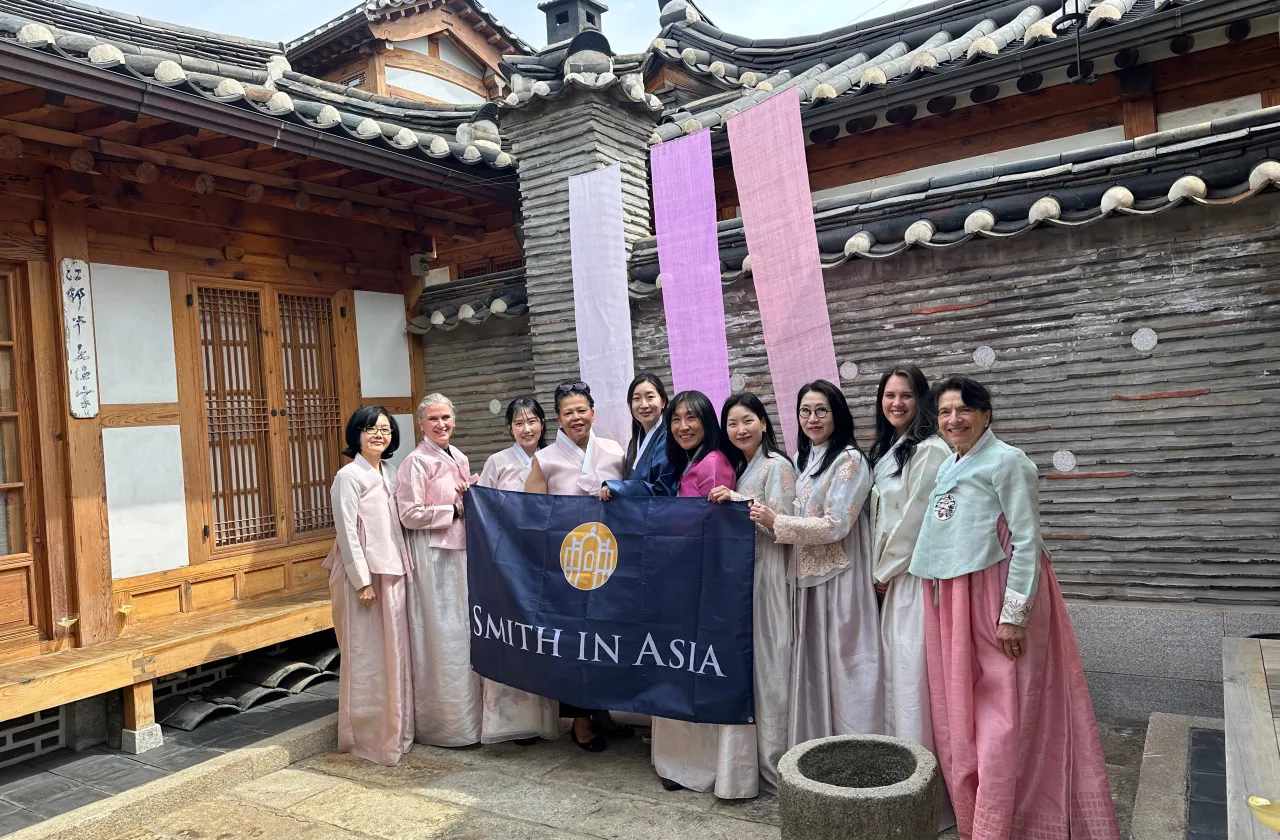 President Sarah Willie-LeBreton and Smith College alums hold a Smith in Asia banner.