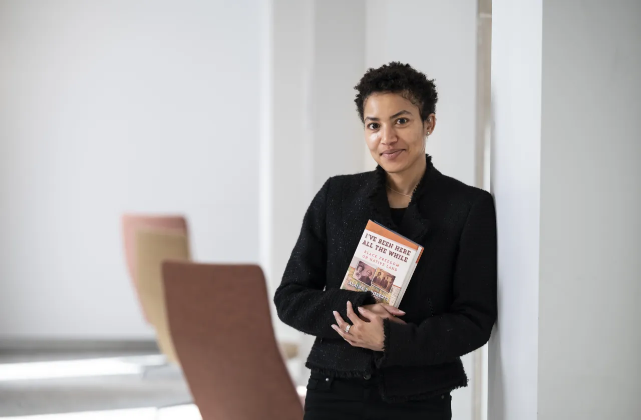 Cromwell Day speaker Alaina Roberts holds her book on Native American and Black history