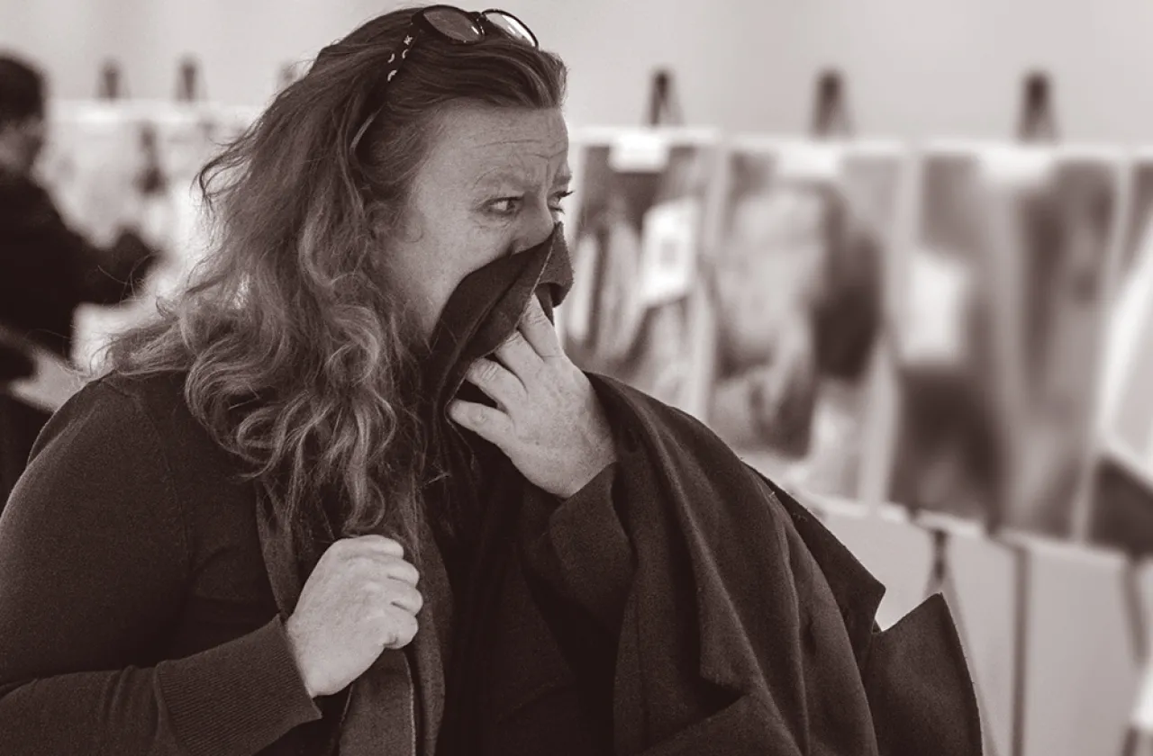 A woman viewing the exhibition of Caesar photographs