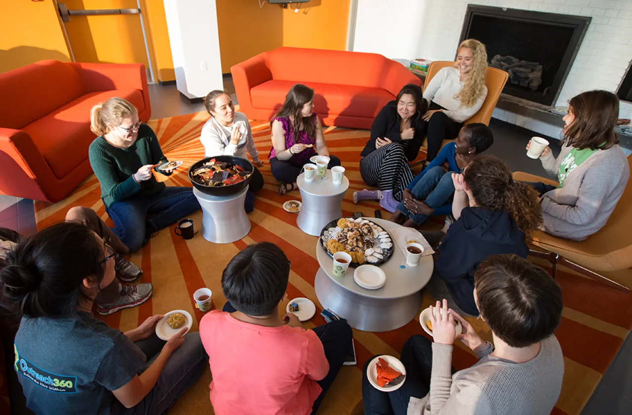 Group of students sitting in a circle having tea