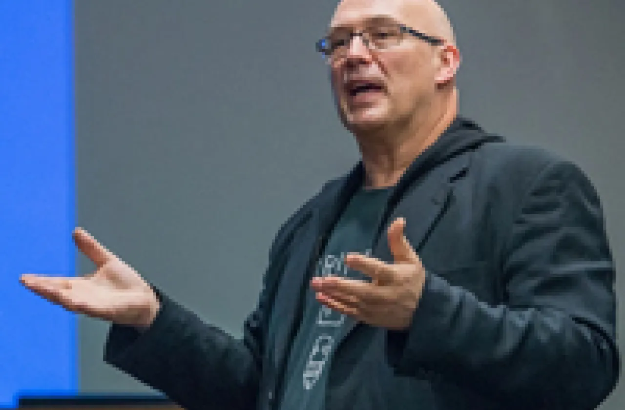 Frazer Ward speaking and demonstrating with his hands in front of a class