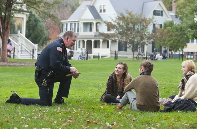 Campus police talking to a group of students