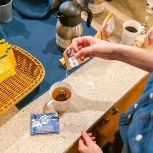 A person making a mug of one of the Smith teas.