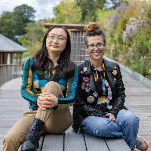 Shiya Cao and Heather Rosenfeld sit on a bench near Paradise Pond