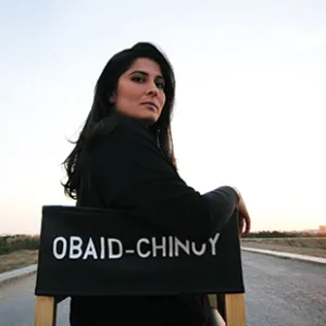 Photo of Sharmeen Obaid-Chinoy sitting in a director's chair