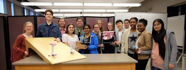 Students with the assistive devices they created