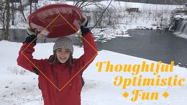 Harriet Wright ’22, in a winter scene with sled held overhead.