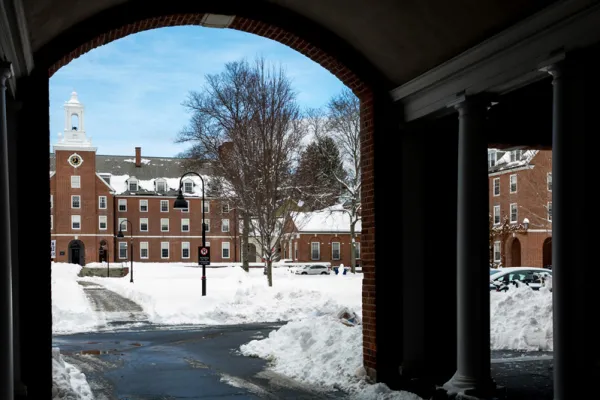 winter courtyard and blue sky seen through an archway