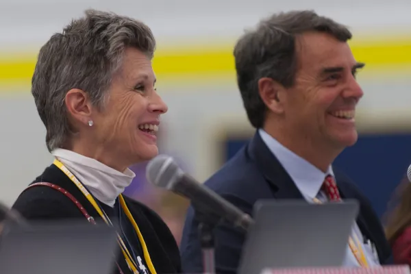 Melisa Parker and Tim Draper smiling during a presentation