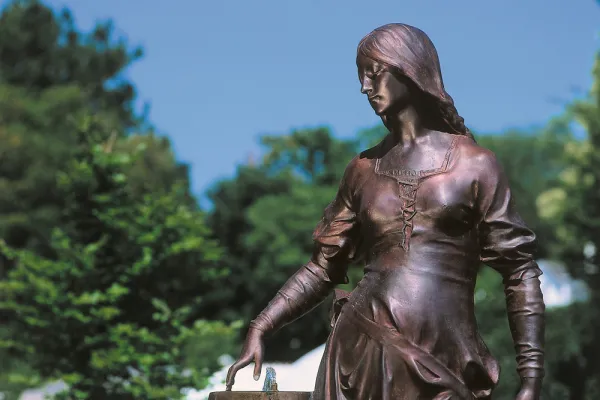 Statue of a woman gazing downward contemplatively