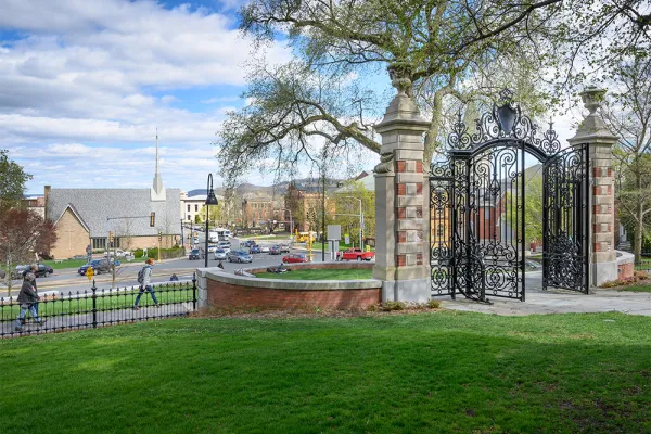People walking past the Grecourt Gates