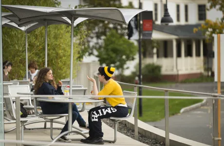 Two students sitting outside of the Campus Center.