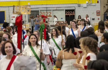 A group of alums from all different class years walk into the Ivy Day ceremony