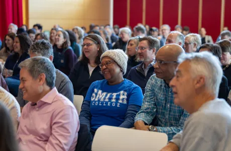 A Family listens to President Willie-LeBreton's welcome speech during Family Weekend.