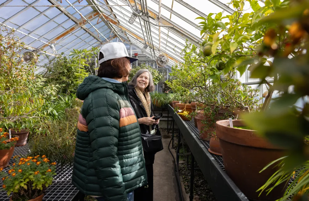 Alums smile in the botanic garden during the 2025 Come Home to Smith event.