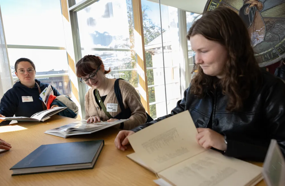 Alums look through archival materials in the library during Come Home to Smith 2025