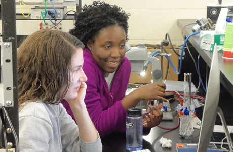 Two students at computer in lab