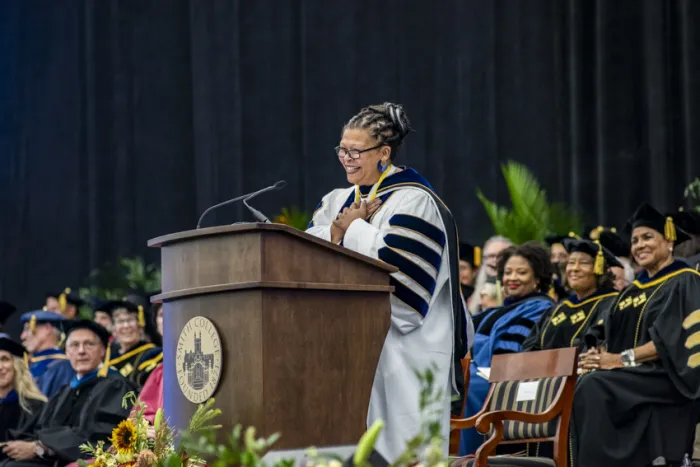 President Sarah Willie-LeBreton standing at the podium during the installation ceremony.