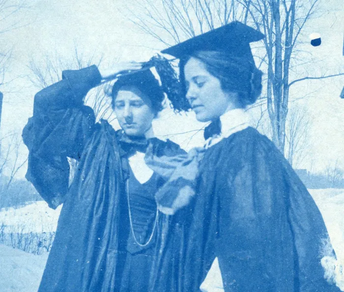 Two members of the class of 1895 in caps and gowns on Rally Day.