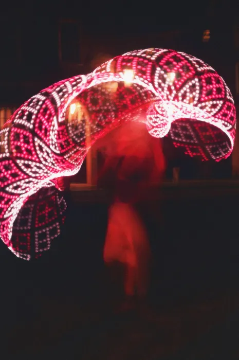 Una Fonte is a blur of pink color while dancing with LED hula hoops at night