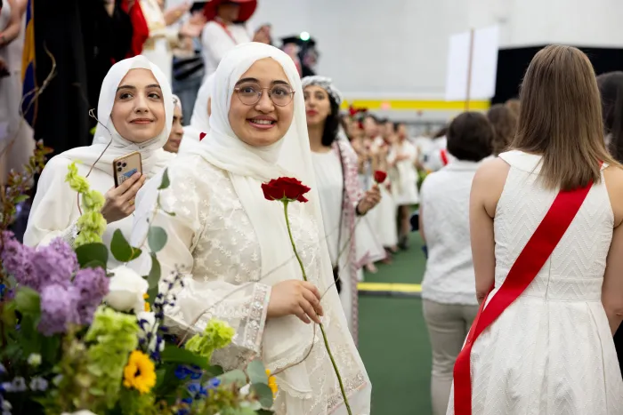 A student holding a rose during Ivy Day