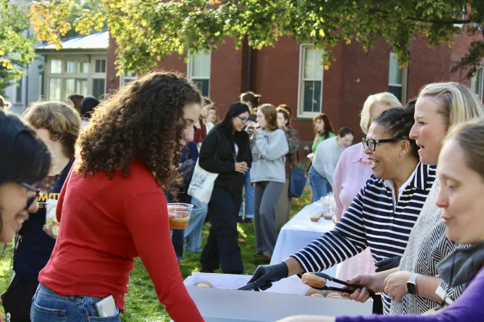 President Sarah handing out donuts on Mountain Day