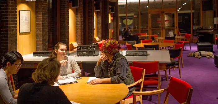 Interior of Josten Library with four students working at a table