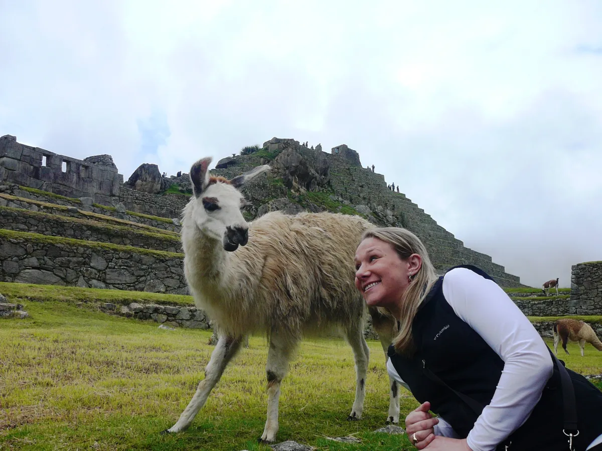 A woman poses with a llama