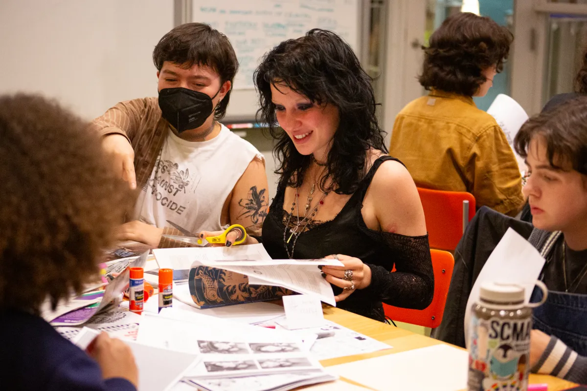 Students smile while working with zines at ZineFest