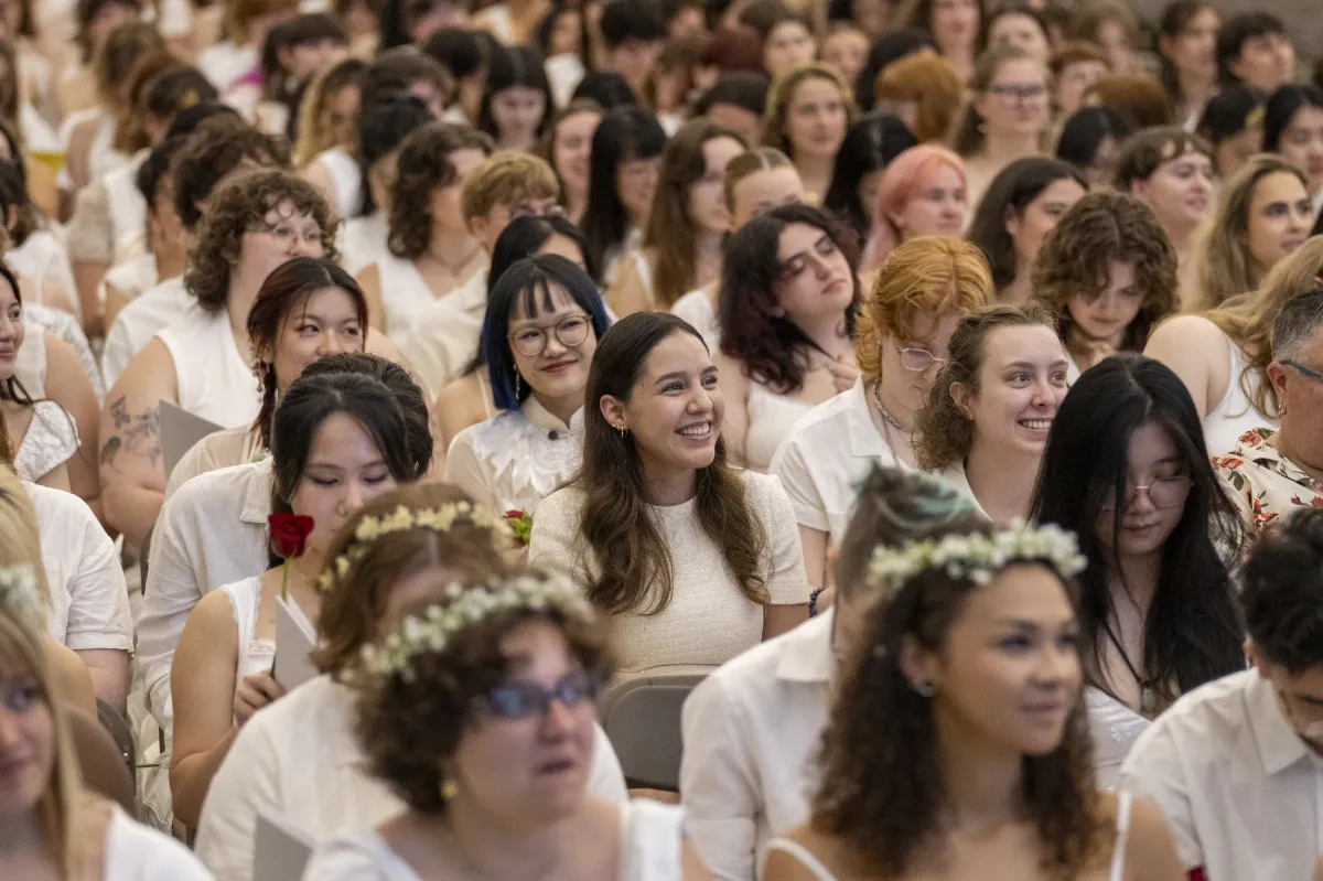 A group of seniors dressed in white in the crowd during Ivy Day