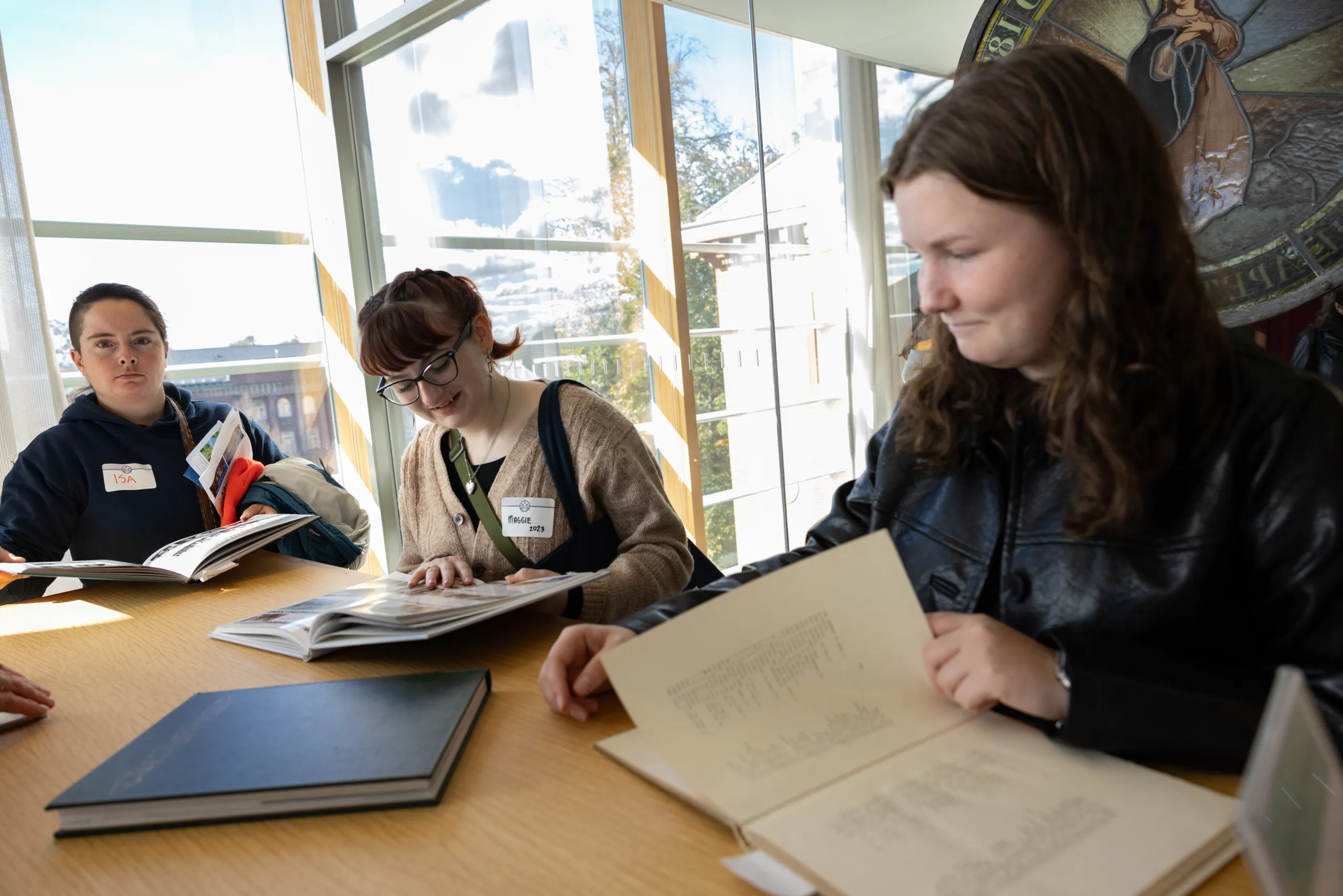 Alums look through archival materials in the library during Come Home to Smith 2025