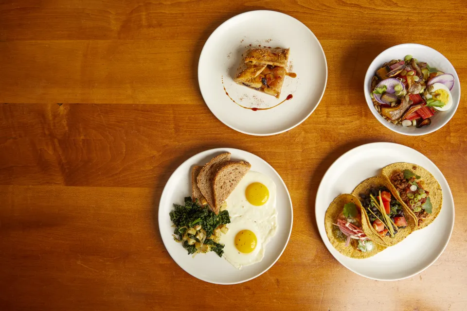 Aerial view of four plates of food prepared at Smith.