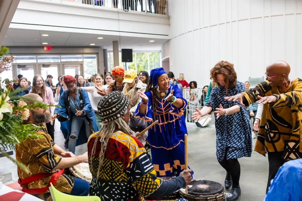 Drummers and dancers joyfully performing in the Campus Center.