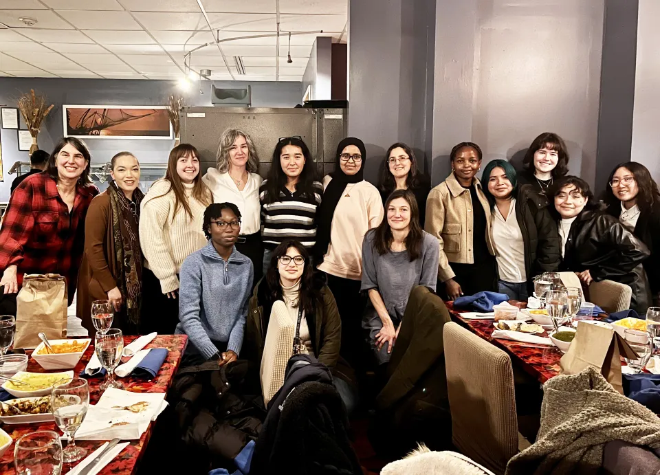 A group of students at a restaurant for a networking dinner.