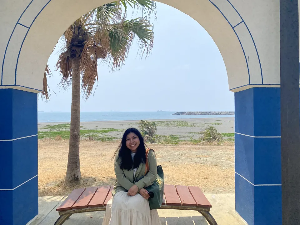 Zia Smith sitting in the doorway of a desert landscape