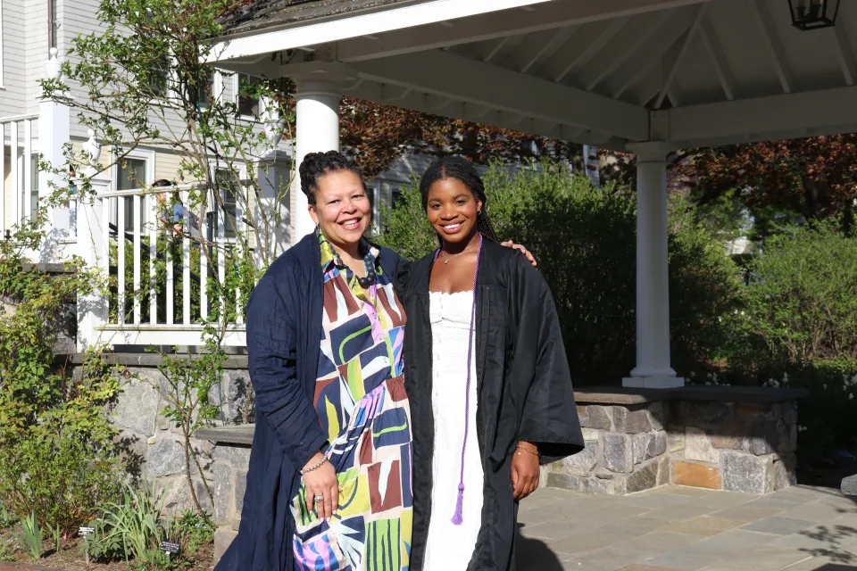 Alliyah Logan poses with President Sarah Willie-Lebreton in Trudy's Garden in front of a gazebo.