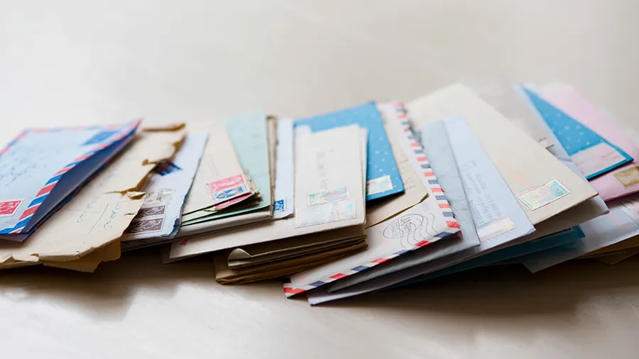 Assorted pieces of mail on a plain background