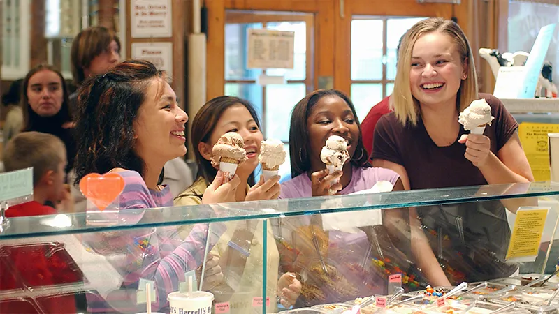 Four students eating ice cream in a Northampton shop