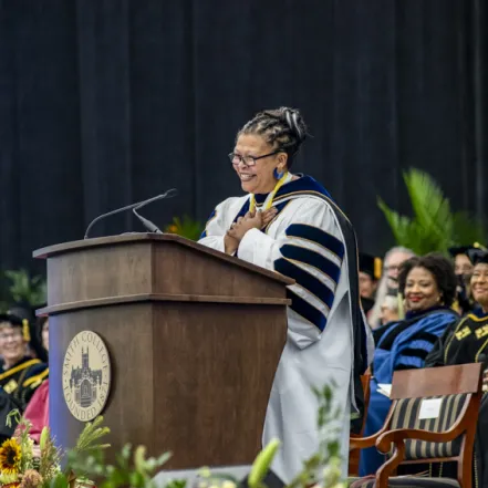 President Sarah Willie-LeBreton standing at the podium during the installation ceremony.