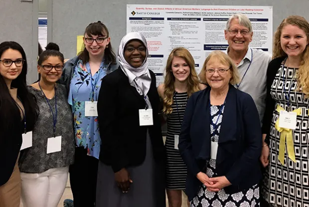 A group of students posing with one of their posters at the Society for Research in Child Development (SRCD) Convention in Austin TX in April 2017. 